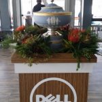 Red floral arrangement on a dell podium