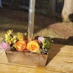 Floral arrangement in a wooden planter