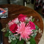 Red roses and pink flowers on a table
