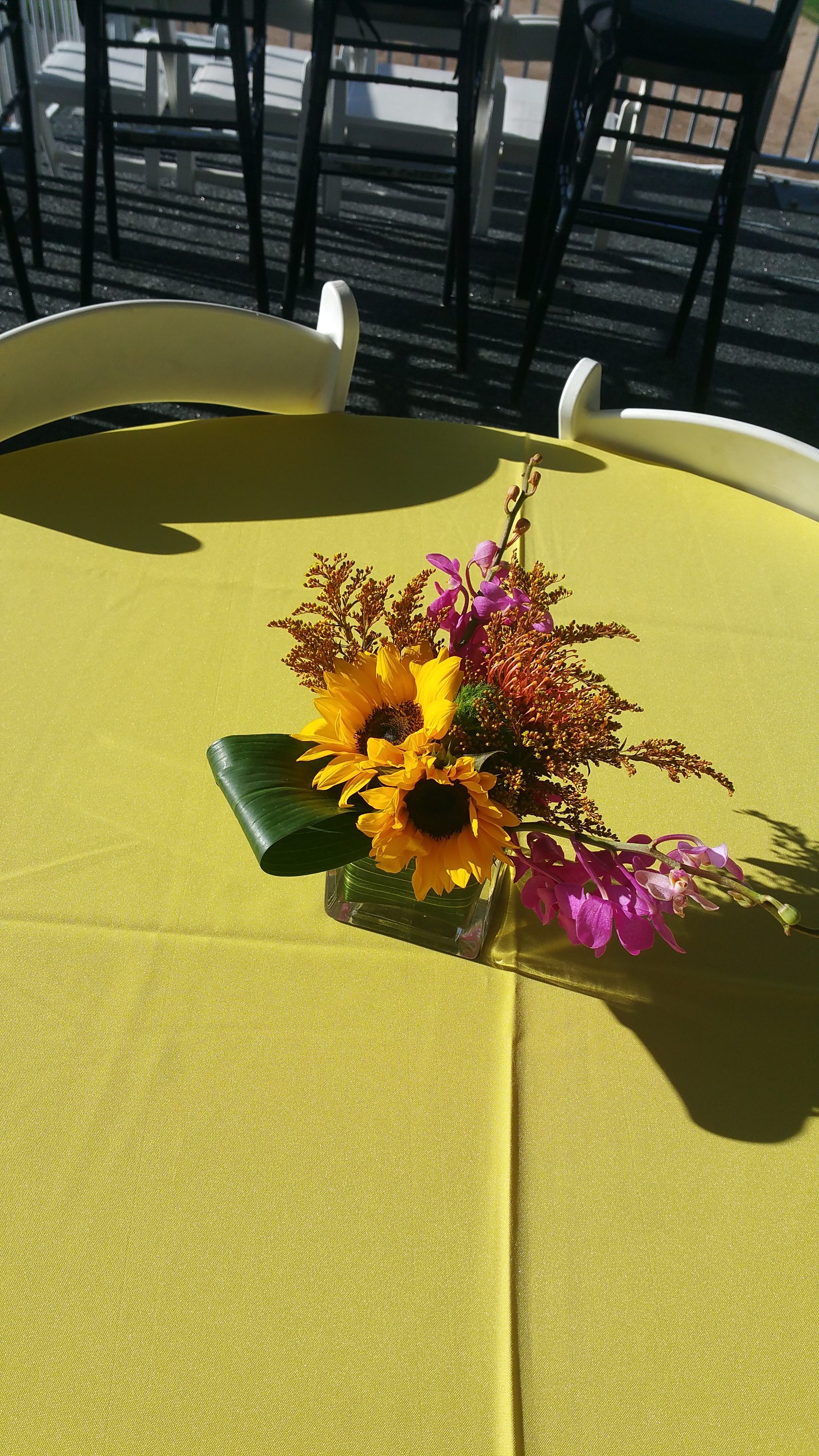 Table arrangement with yellow and pink flowers