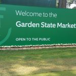 Plants in front of welcome to the Garden State Market sign